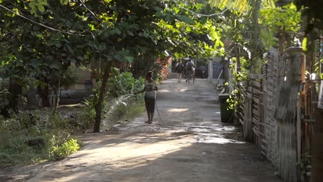 Woman-Spraying-a-Hose-in-the-Road