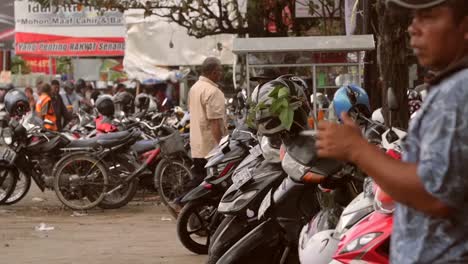 Man-Standing-by-a-Row-of-Motorcycles