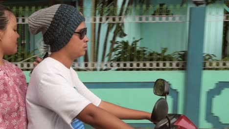 Couple-Riding-Motorbike-Through-Indonesian-Village