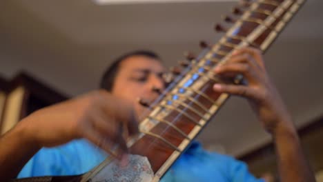 Man-Plucking-a-Sitar