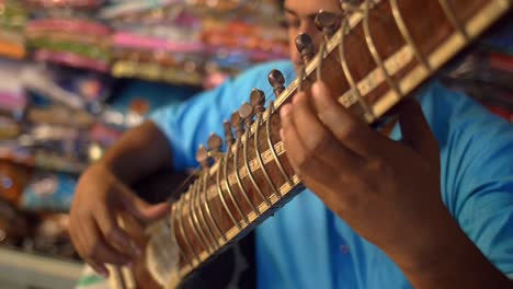 Close-Up-Panning-Shot-of-a-Man-Playing-a-Sitar