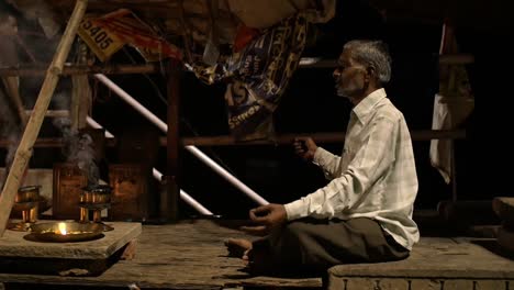 Cross-Legged-Man-Partaking-in-Ganga-Aarti