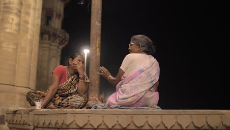 Two-Ladies-Sitting-and-Talking-at-Night