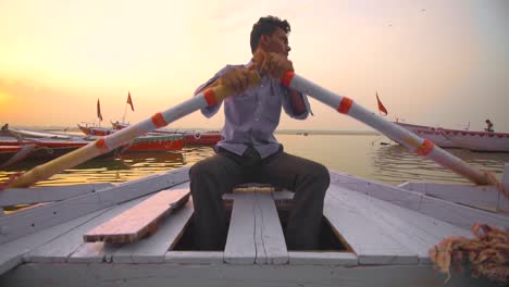 Panning-Shot-of-A-Man-Rowing-a-Boat