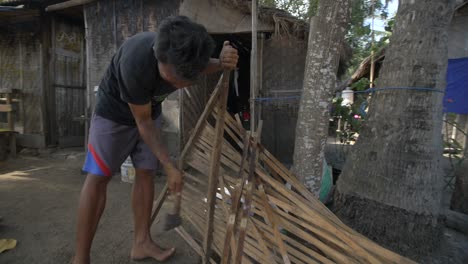 Orbiting-Shot-of-Man-Dismantling-a-Fence