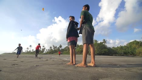 Smiling-Boys-Flying-a-Kite-on-a-Beach