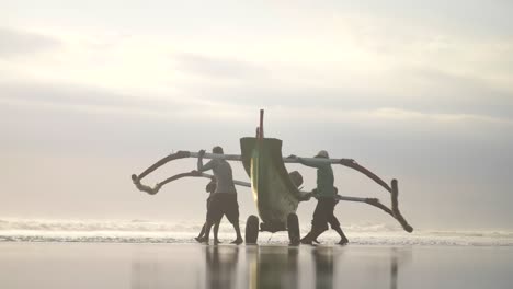 Four-People-Pushing-a-Canoe-into-the-Sea