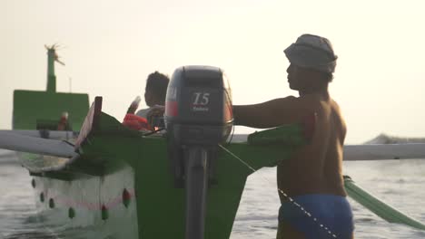 Man-Adjusting-Propeller-on-a-Canoe