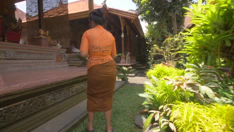 Woman-Arranging-Offerings-in-a-Temple