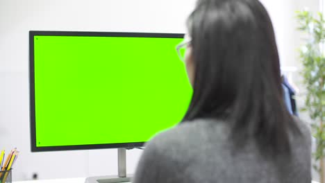 Tracking-Past-Woman-Working-at-Computer-Chroma-Screen