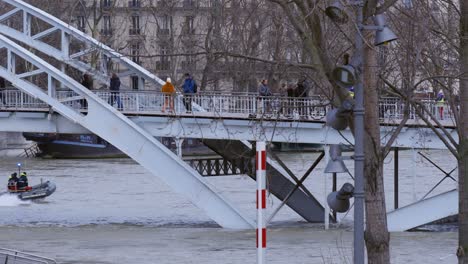 Pedestrians-Walking-Over-Flooded-Bridge-in-París