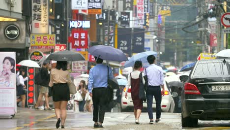 People-Walking-Down-Wet-Seoul-Street