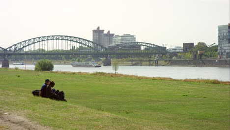 Couple-on-Riverbank-in-Cologne-4K