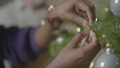 Female-Hands-Decorating-Christmas-Tree-1