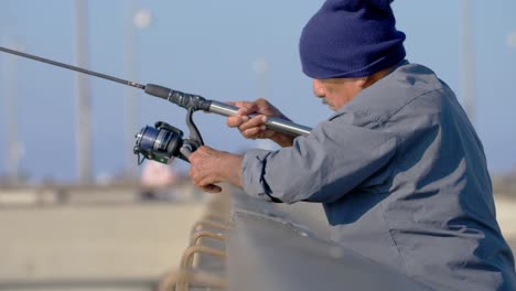 Man-Reeling-in-Fishing-Line