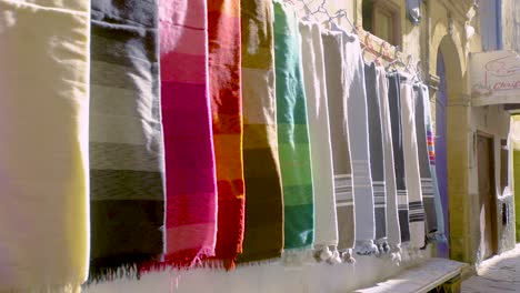 Colourful-Fabrics-Hanging-From-Wall