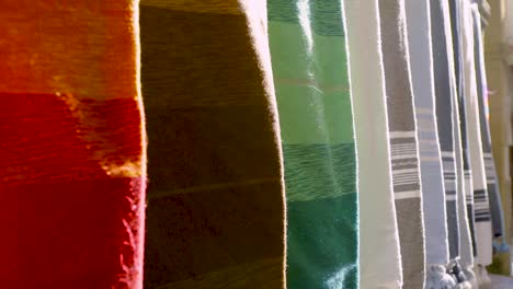 Colourful-Fabrics-Hanging-From-Wall-CU