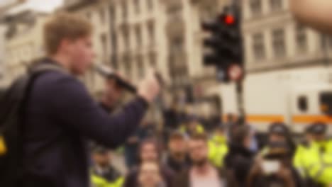 Blurry-Protester-Speaking-into-Microphone