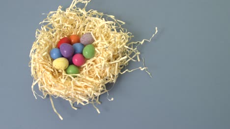 Placing-Easter-Egg-in-Straw-Nest