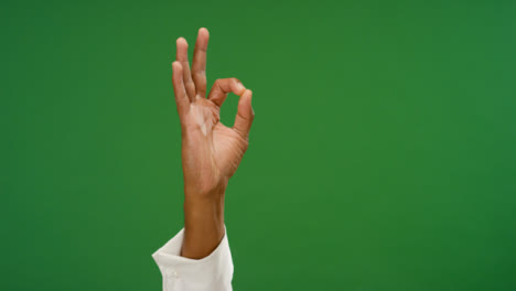 Male-hand-making-OK-gesture-on-green-screen