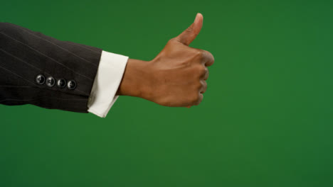 Male-hand-making-thumbs-up-gesture-on-green-screen