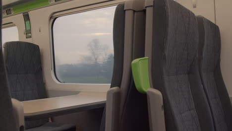 Looking-out-train-window-passing-trees-and-houses