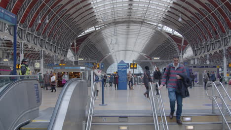 Man-walking-down-stairs-from-train-station-concourse