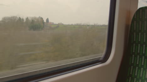 Looking-out-train-window-passing-road