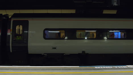 Man-walking-on-platform-as-train-moves-past