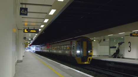 Train-arriving-at-station-with-passenger-waiting