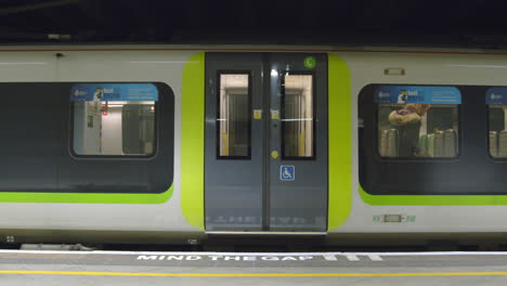 Woman-walks-door-aisle-as-train-leaves