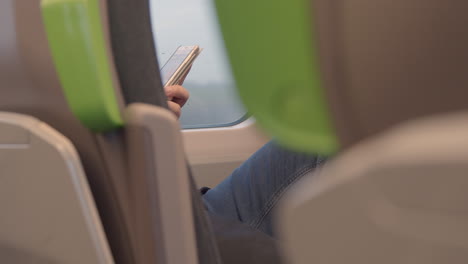 Man-using-phone-on-a-train