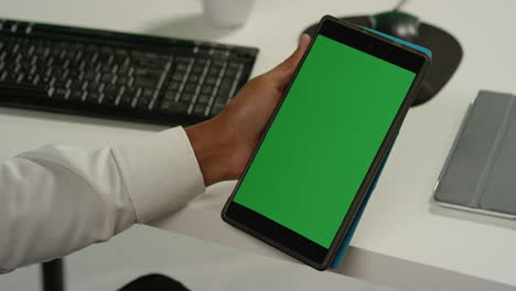 Cu-Mann-Am-Schreibtisch-Hält-Tablet-Mit-Grünem-Bildschirm