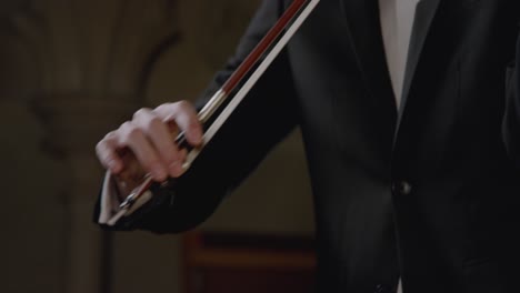 Close-Up-Of-Male-Using-Bow-To-Play-Violin