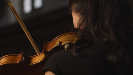 Rear-View-Of-Female-Violinist-Playing-Violin