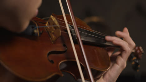 Close-Up-Bow-And-Fingers-On-Violin