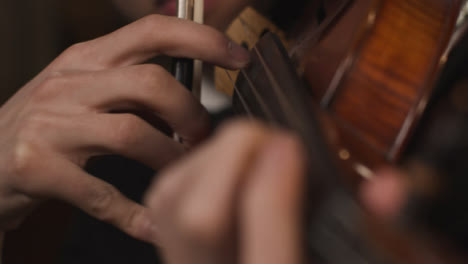 Close-Up-Hands-Of-Male-Violinist-Plucking-Strings-On-Violin