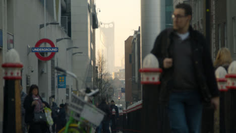 Pedestrians-Walking-In-A-Busy-London-Street-Near-Tube-Station,-Daytime