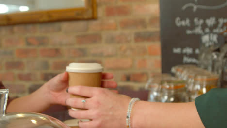 Handing-Coffee-to-Customer-in-Cafe-01