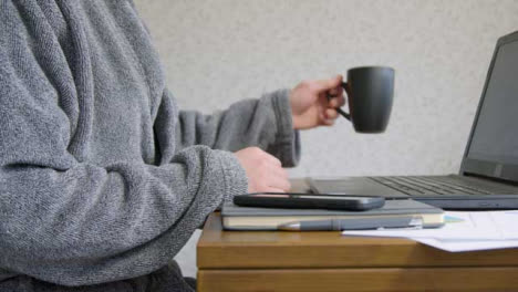 Male-Working-From-Home-Drinking-From-Cup