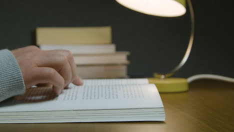 Close-Up-Side-View-Male-Reading-Book-at-Night