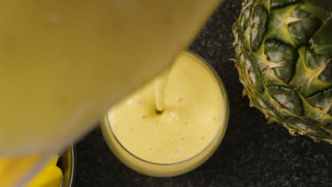 Overhead-Pouring-Mango-Smoothie-into-Glass