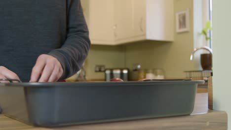 Man-Putting-Onions-in-Roasting-Tray