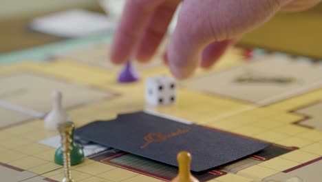 Close-Up-Hand-Rolling-Die-in-Cluedo-Board-Game
