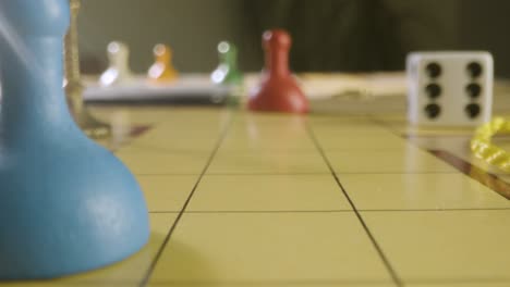 Close-Up-Rolling-Die-and-Moving-Pawn-in-Cluedo-Game