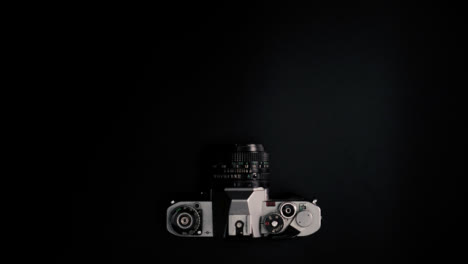 Flat-Lay-Stop-Motion-Retro-Camera-Moving-On-Surface