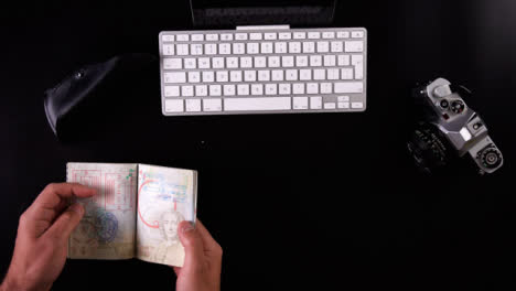 Flat-Lay-Travel-Booking-Passport-Being-Flicked-Through