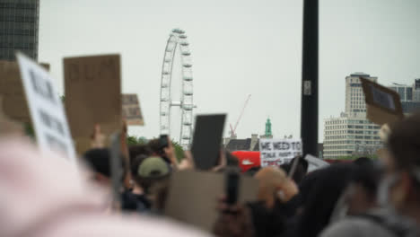 London-Crowd-of-Protesters-March-With-London-Eye-in-Distance