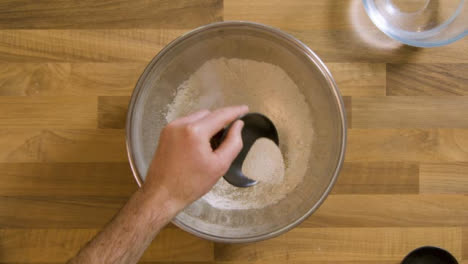 Top-View-Pouring-Yeast-and-Salt-into-Bowl