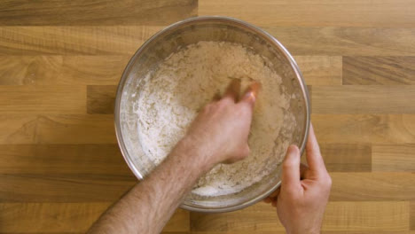 Top-View-Mixing-Ingredients-Into-a-Dough